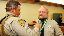 Park County Sheriff's Deputy Brian Elliott-Pearson is seen receiving a Meritorious Service medal for saving a life in 2015. Park County Sheriff's Deputy Brian Elliott-Pearson is seen receiving a Meritorious Service medal for saving a life in 2015.