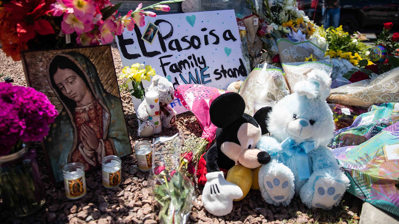 Locals bring flowers, stuffed animals, candles and posters to honor the memory of the victims of the mass shooting occurred in Walmart on Saturday morning in El Paso on Sunday, August 4, 2019.