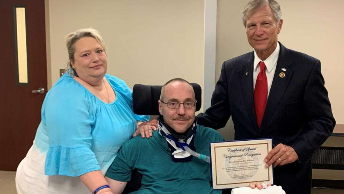 From left to right: Kami Whitten (wife), Deputy Richard Whitten, and Rep. Brian Babin.