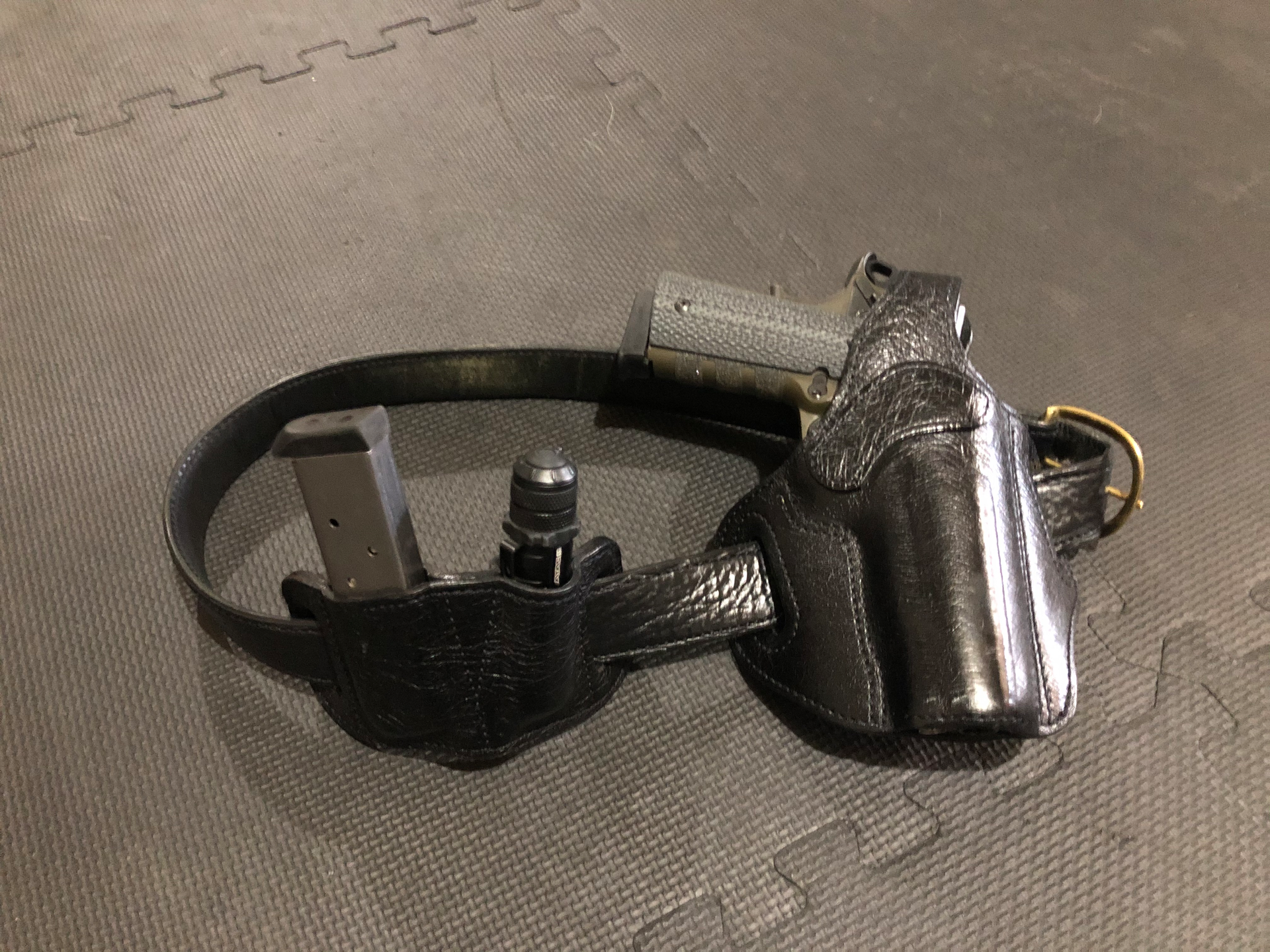 The classic 1911 .45ACP, spare magazine and a good quality flashlight - a very typical CCW rig.