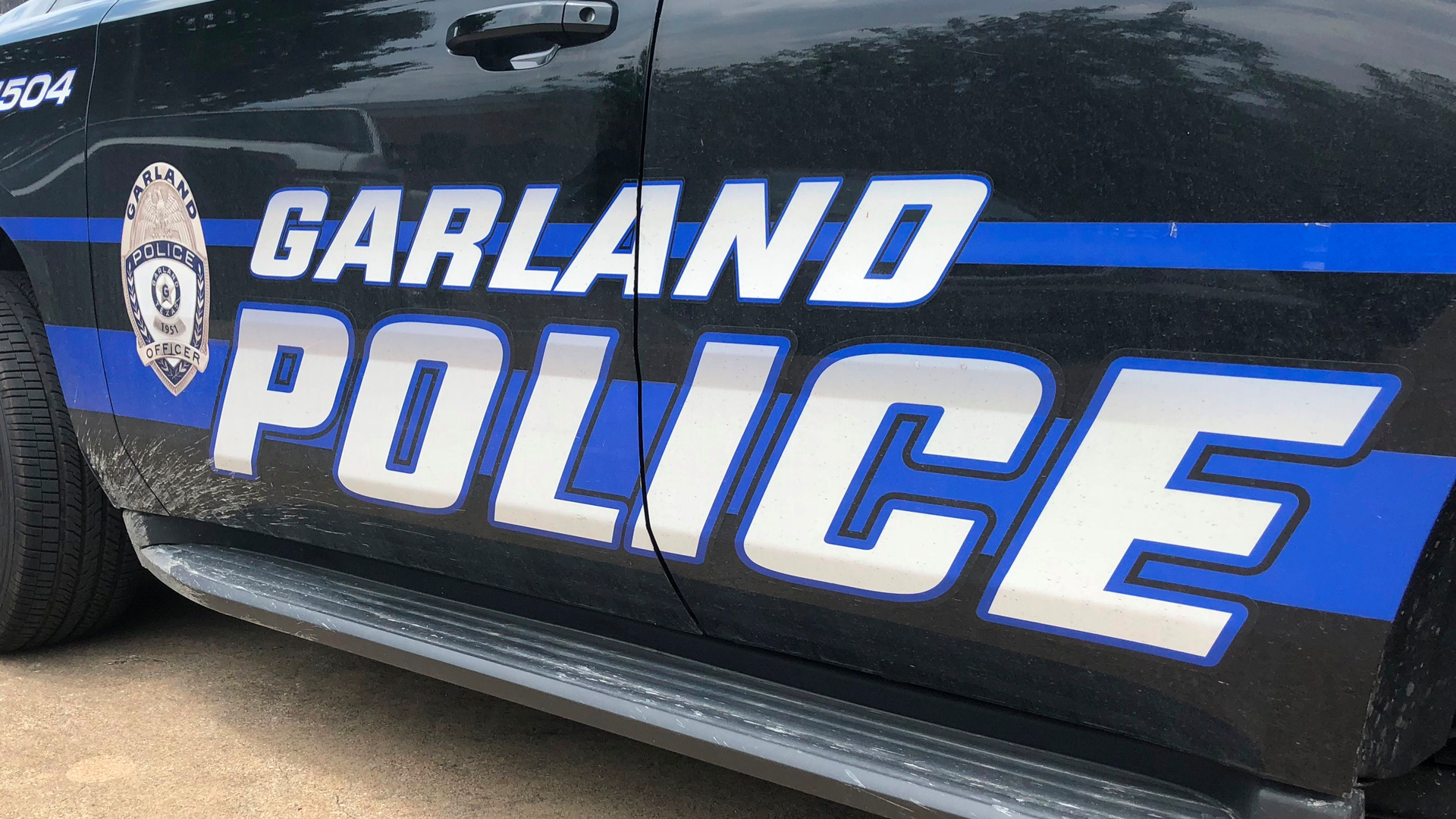 A Dallas man was arrested during a manhunt Sunday after police say he was caught on video running over and dragging a Garland police officer with a car.