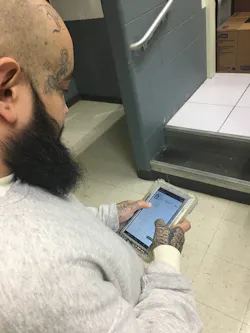 Jesus Villegas, an incarcerated individual at the Kendall County Sheriff's Office in Illinois, uses the photo attachment featured of the eMessaging application on SecurueView Tablets from Securus Technologies to view pictures of photos of family and friends. Jesus Villegas, an incarcerated individual at the Kendall County Sheriff's Office in Illinois, uses the photo attachment featured of the eMessaging application on SecurueView Tablets from Securus Technologies to view pictures of photos of family and friends.