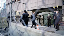 Pedestrians were cleared one at a time through one gate outside the Hennepin County Courthouse, site of the trial of former Minneapolis police officer Derek Chauvin in the death of George Floyd. Pedestrians were cleared one at a time through one gate outside the Hennepin County Courthouse, site of the trial of former Minneapolis police officer Derek Chauvin in the death of George Floyd.