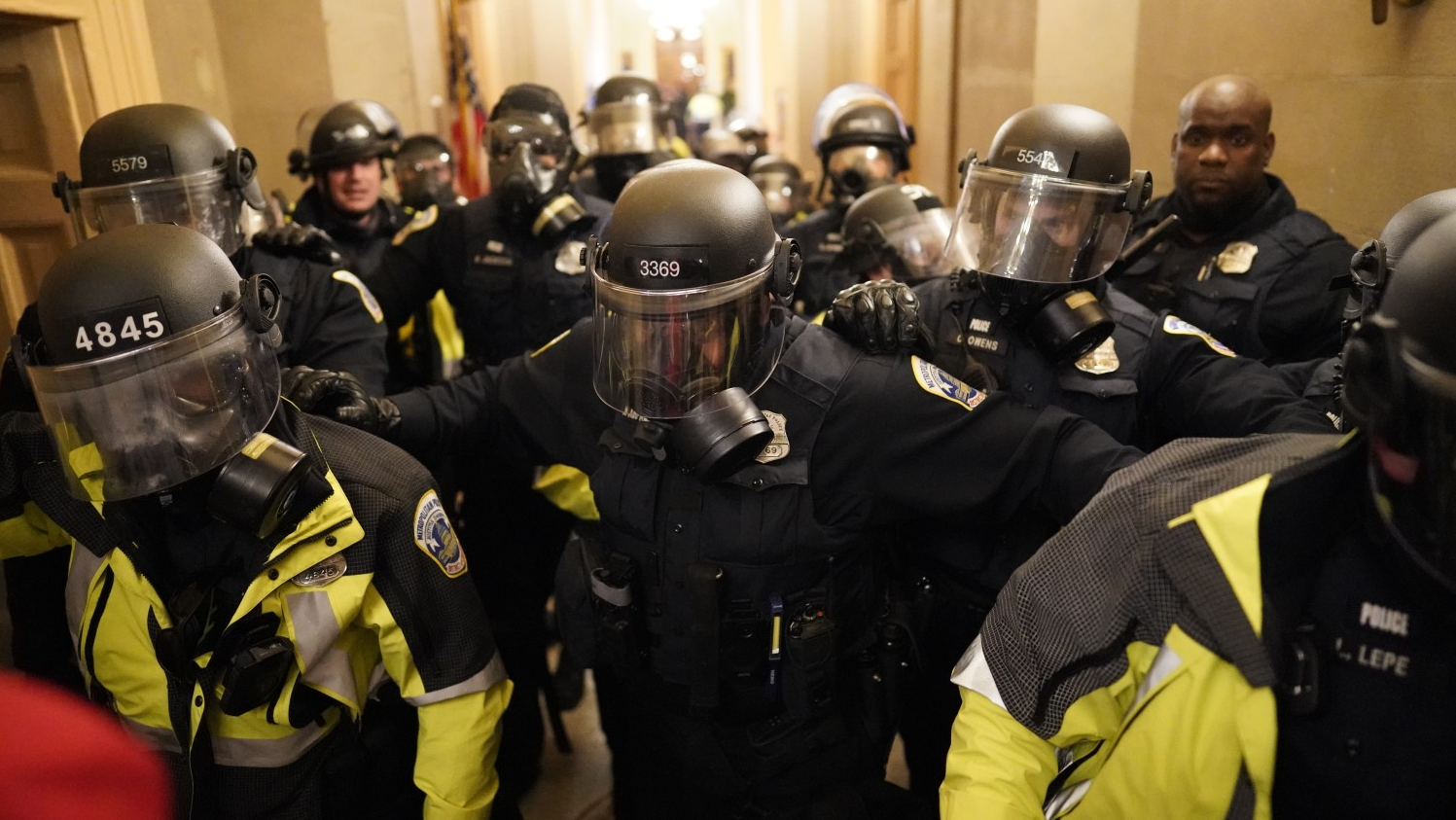 Riot police clear the hallway inside the Capitol on Jan. 6, 2021, in Washington, D.C.