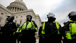 Police officers in riot gear stand guard while supporters of President Donald Trump protest on the steps of the U.S. Capitol building on Capitol Hill in Washington, D.C., on Jan. 6. Police officers in riot gear stand guard while supporters of President Donald Trump protest on the steps of the U.S. Capitol building on Capitol Hill in Washington, D.C., on Jan. 6.