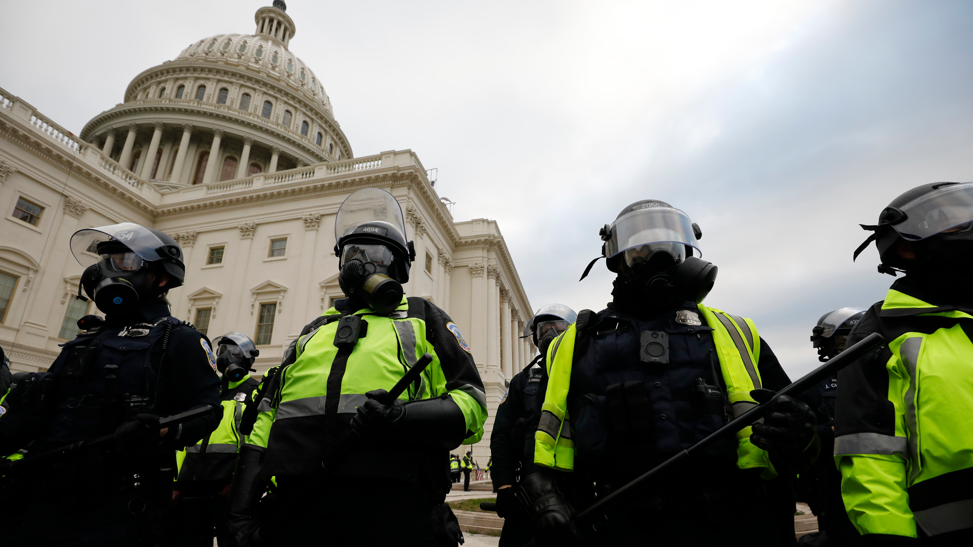 Police officers in riot gear stand guard while supporters of President Donald Trump protest on the steps of the U.S. Capitol building in Washington, D.C., on Jan. 6.