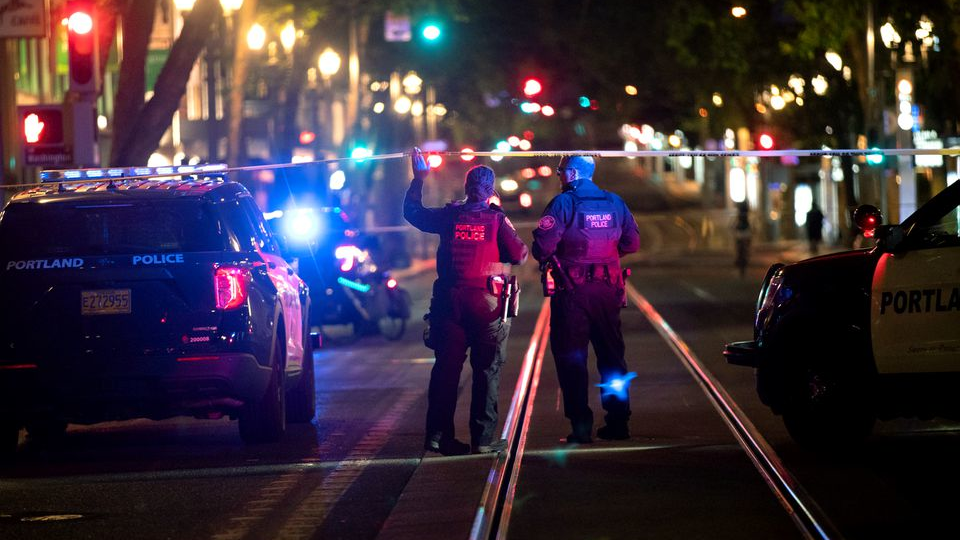 Police investigate a July 24 shooting in downtown Portland, OR, near Southwest Fifth Avenue and Washington Street.