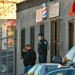 Baltimore Police Commissioner Michael Harrison talks on a phone outside an East Baltimore barbershop following a fatal shooting involving an off-duty officer. Baltimore Police Commissioner Michael Harrison talks on a phone outside an East Baltimore barbershop following a fatal shooting involving an off-duty officer.