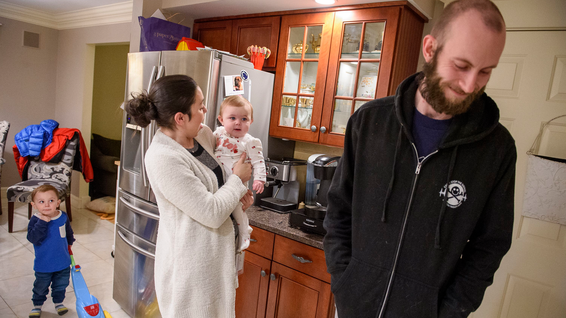 Farmington, CT, Police Officer James O'Donnell, who suffered significant injuries in September when he was hit by a driver fleeing a crime scene in a stolen car, hangs out at home with son Andrew (far left), wife Kris and daughter Saoirse.