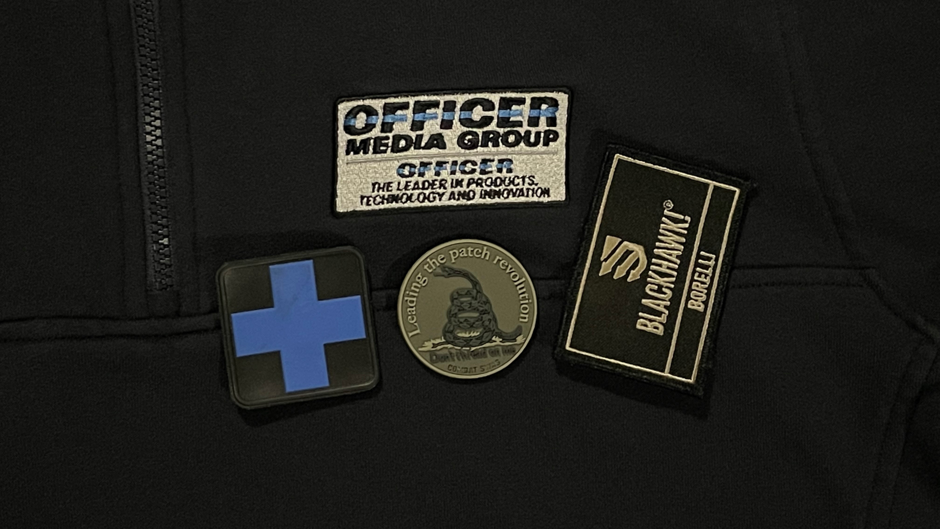 An embroidered shirt from 511 Tactical, challenge coin from Combat Swag and a personalized patch from BLACKHAWK. Examples of marketing materials.