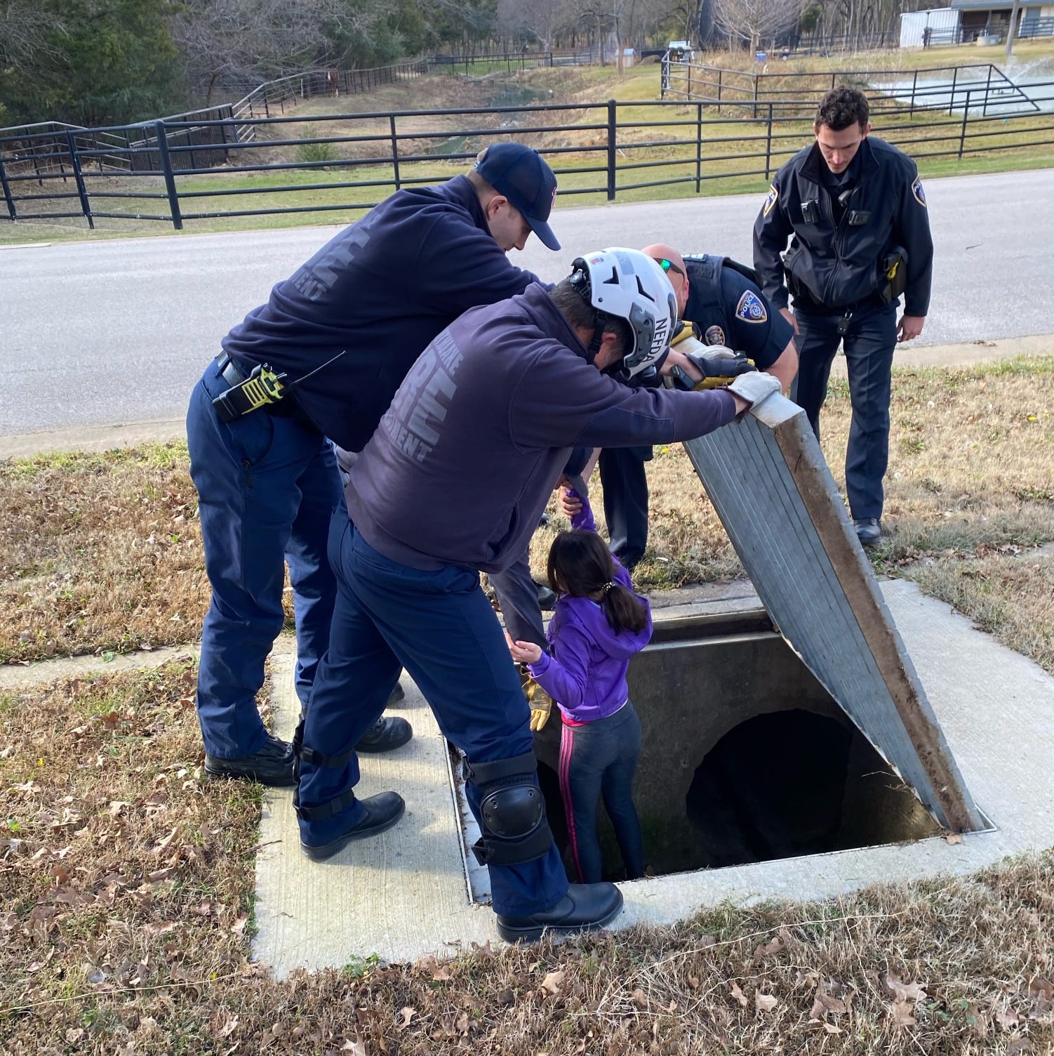 Southlake, TX, police officers rescue an 11-year-old girl who was trapped by snakes and a heavy inside a drainage pipe Wednesday.