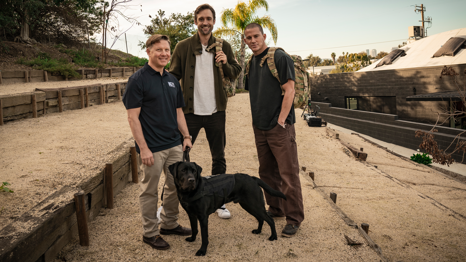 (Left to right) Navy Captain Jon, with Labrador Winston; 'Dog' Co-Director Reid Carolin; and 'Dog' Co-Director and Actor Channing Tatum.