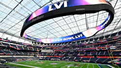 Crews work on the field preparation for Super Bowl LVI as the Oculus video board glows above them on Tuesday at SoFi Stadium in Inglewood, CA. Crews work on the field preparation for Super Bowl LVI as the Oculus video board glows above them on Tuesday at SoFi Stadium in Inglewood, CA.