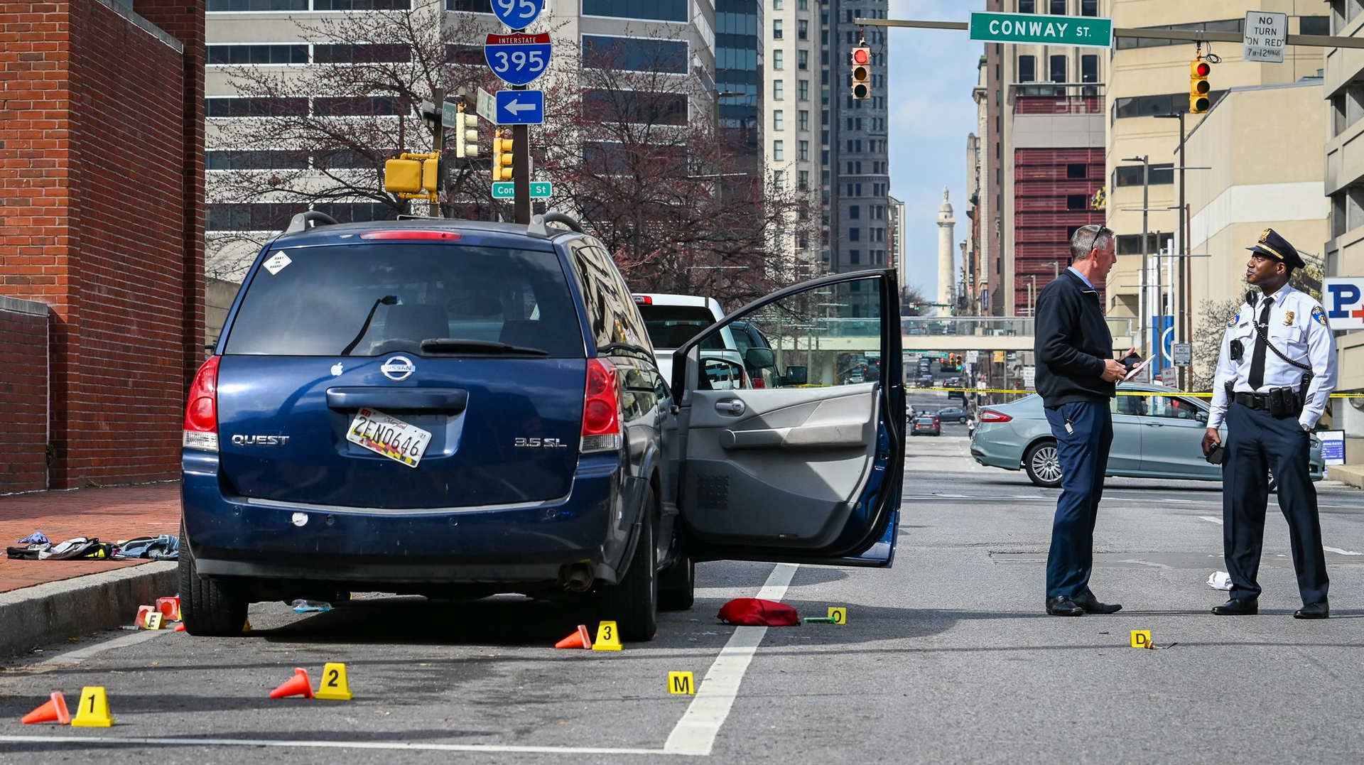Baltimore police investigate the scene of a shooting that killed two people and wounded six others Friday.