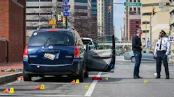 Baltimore police investigate the scene of a shooting that killed two people and wounded six others Friday. Baltimore police investigate the scene of a shooting that killed two people and wounded six others Friday.