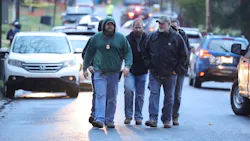 Investigators walk in the vicinity of the scene of a shooting in Lebanon, PA, on Thursday, that left a police officer dead and two seriously wounded. Investigators walk in the vicinity of the scene of a shooting in Lebanon, PA, on Thursday, that left a police officer dead and two seriously wounded.