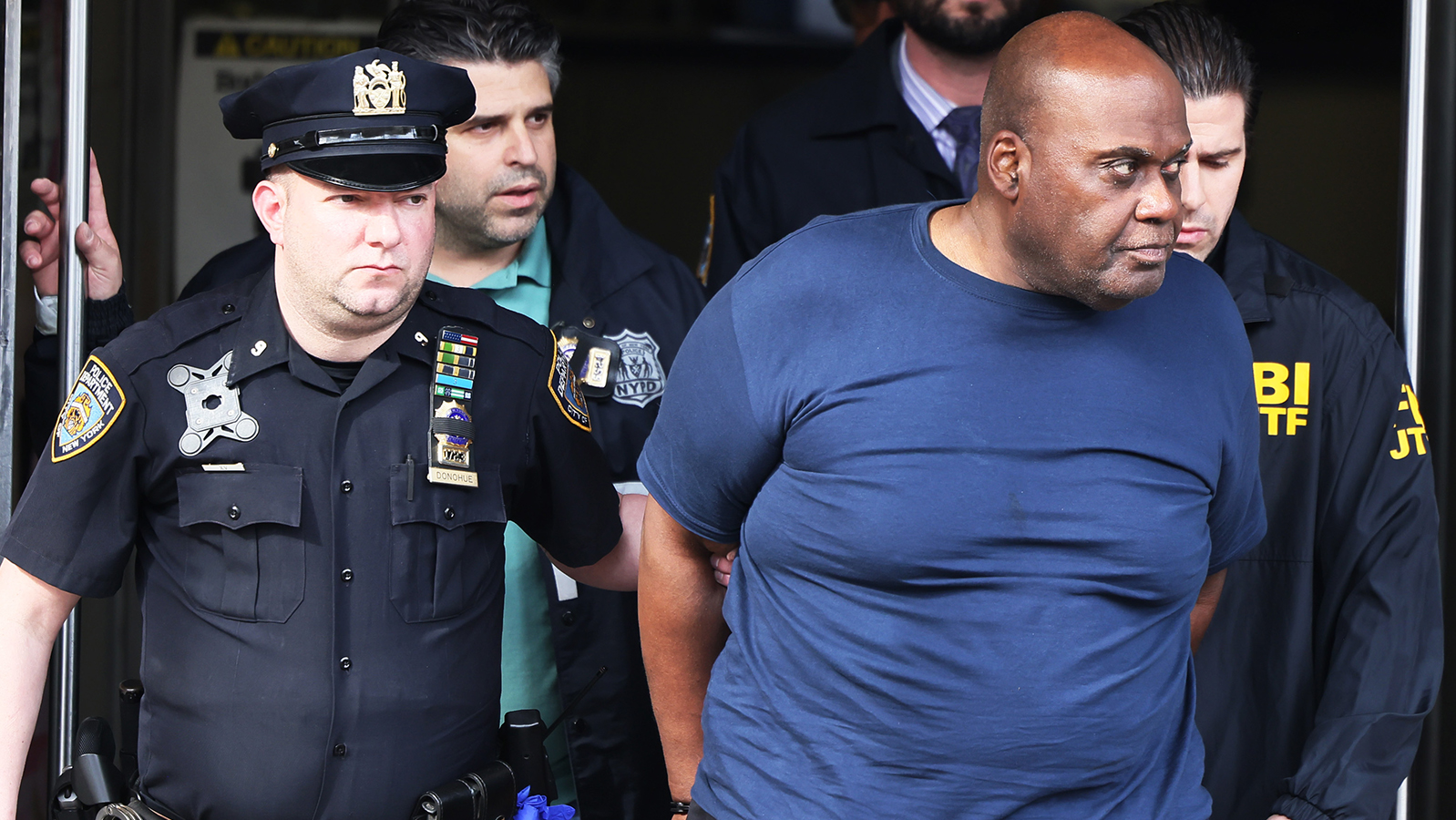 Frank James is led by NYPD officers after his arrest Wednesday in connection to the mass shooting at a Brooklyn subway station earlier this week.