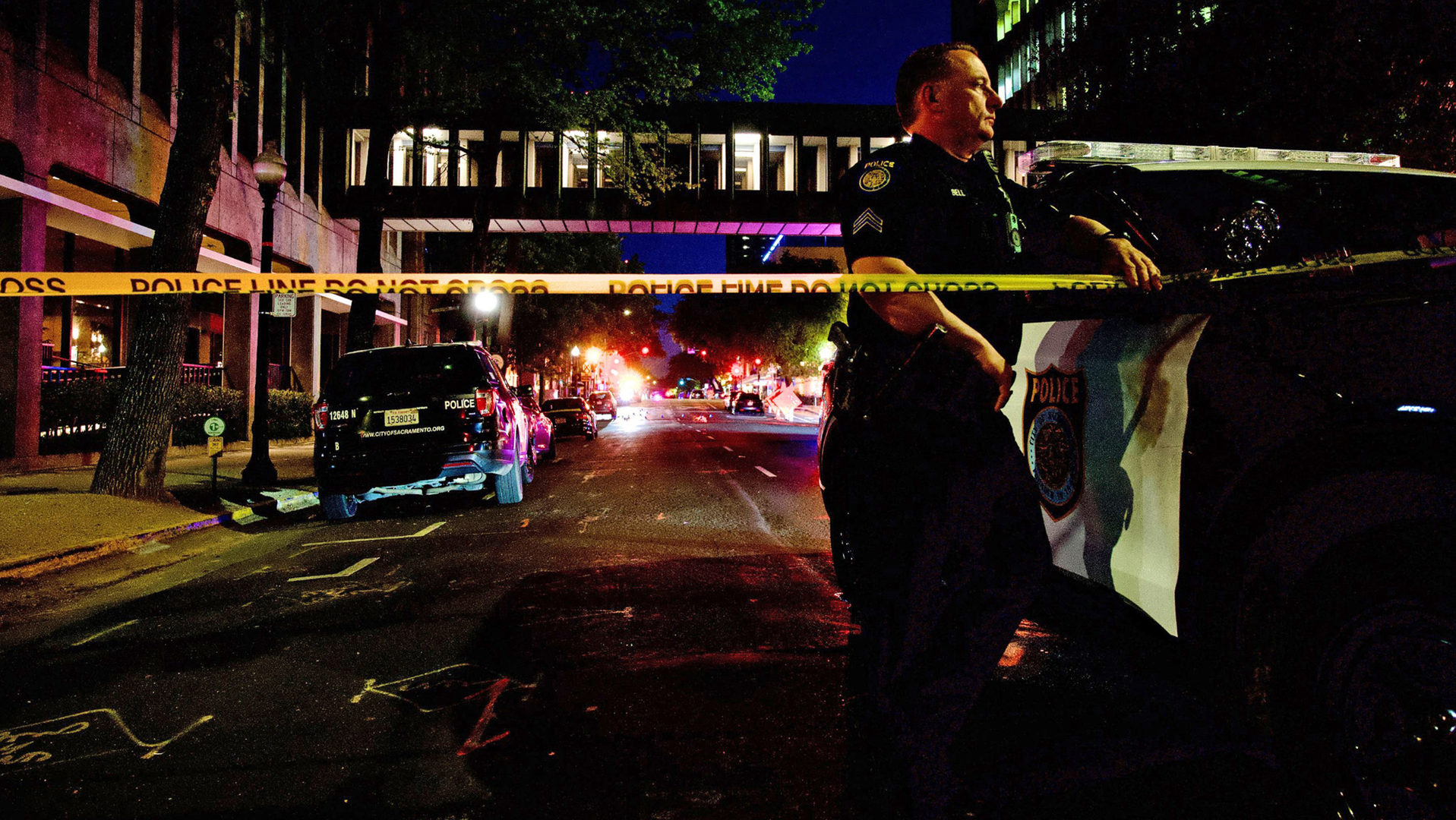 Sacramento, CA, Police Officer David Bell stands watch at the scene of a mass shooting that left six people dead and 12 injured Sunday.