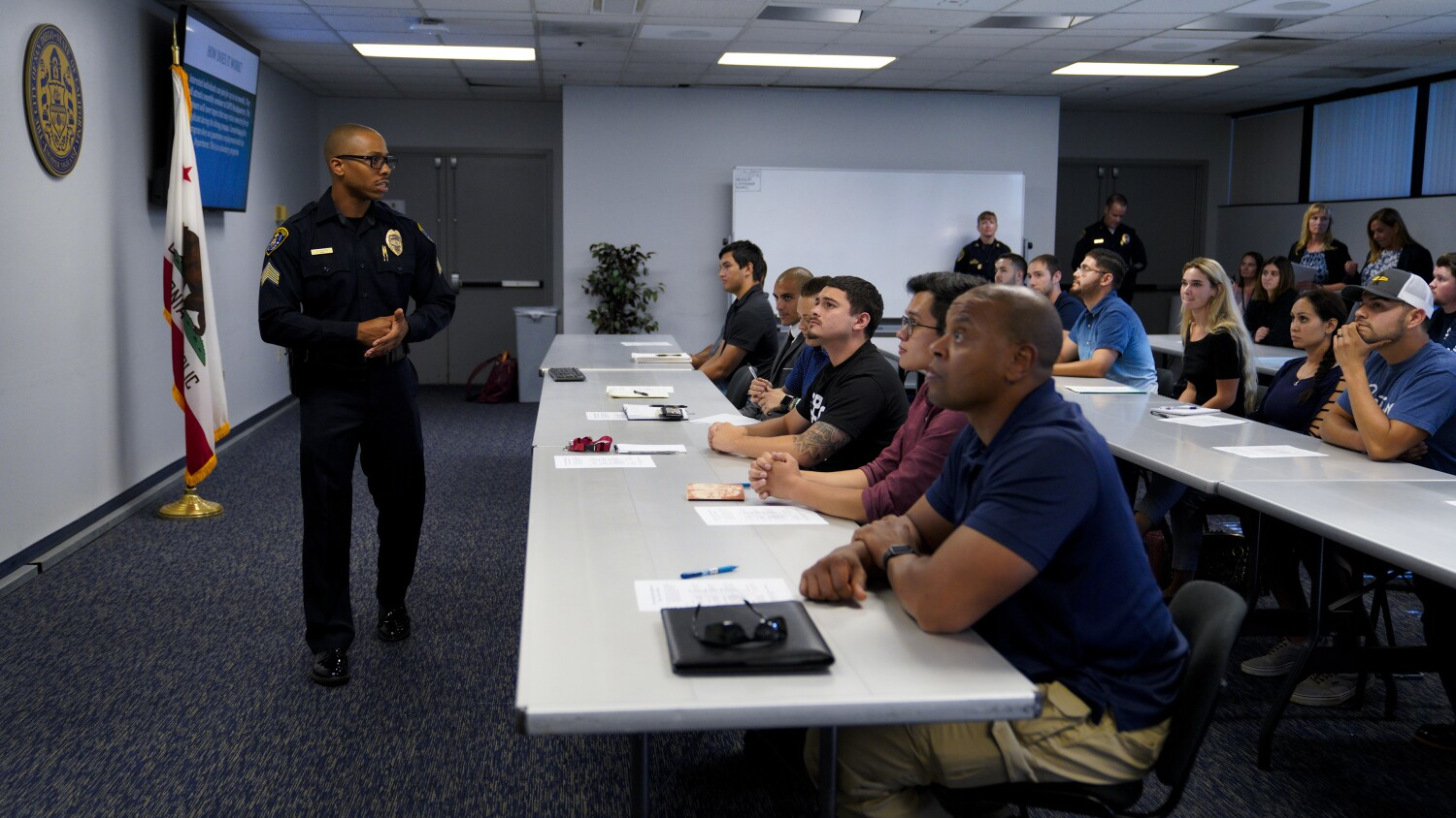 San Diego Police Sgt. Travis Easter addresses potential applicants for the department's hiring process during the Blue Arrow Program last month at police headquarters.