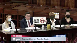 In a screen capture from a New York City Council video, Robert Barrows of the NYPD holds up a 'gun free zone' sign during a City Council Committee on Public Safety meeting Tuesday. In a screen capture from a New York City Council video, Robert Barrows of the NYPD holds up a 'gun free zone' sign during a City Council Committee on Public Safety meeting Tuesday.