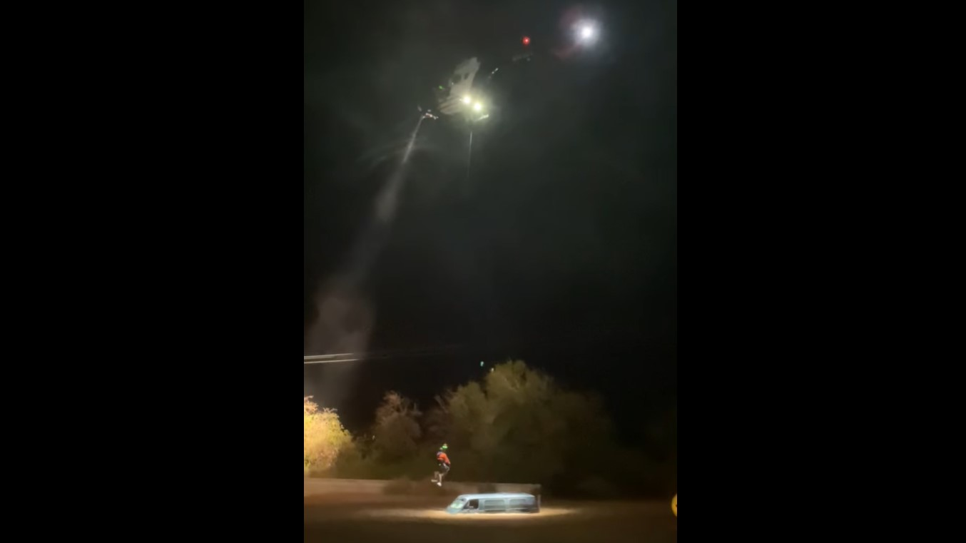 A Las Vegas police helicopter rescues two people trapped in a van caught in fast-moving floodwaters near Mopa early Wednesday.