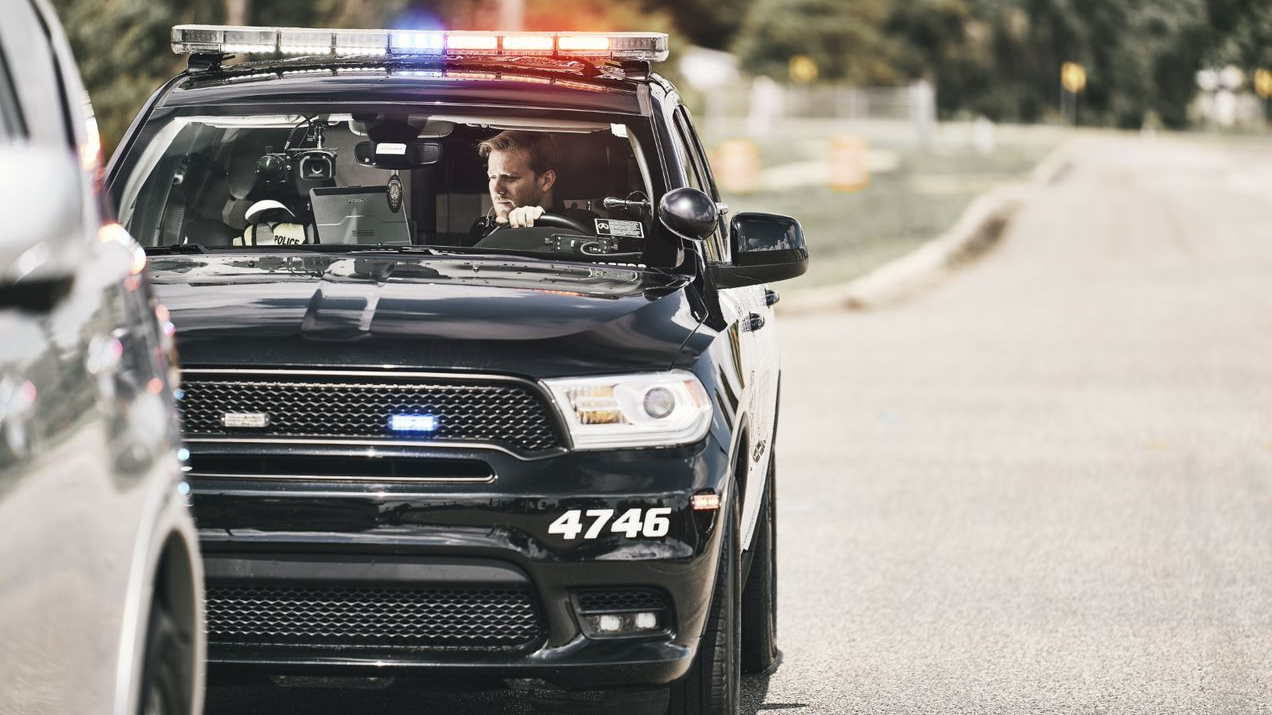 An officer with the Melbourne Police Department is seen inside his patrol car working on a TOUGHBOOK laptop.