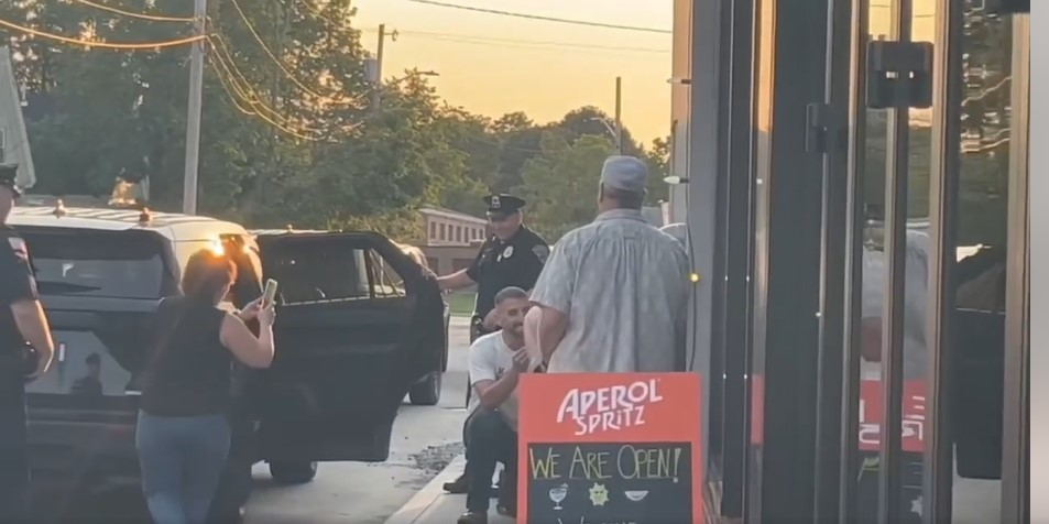 Wayne Morse (center) proposes to his girlfriend after he was fake arrested by Whitman, MA, police earlier this month.