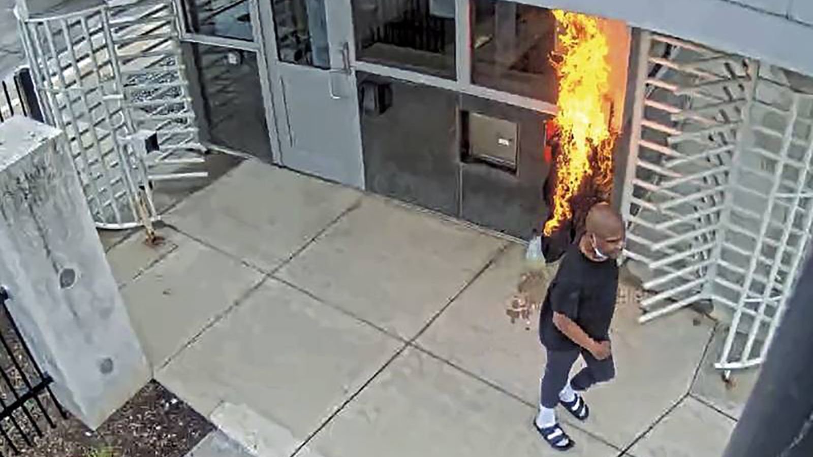 Surveillance footage shows a man setting fire to the guard booth outside the FBI Chicago headquarters on Nov. 4.