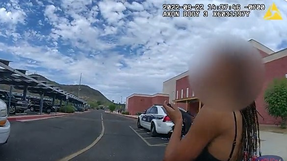 A Phoenix school resource officer disarms a woman who brandished a gun during an on-campus domestic dispute in September.