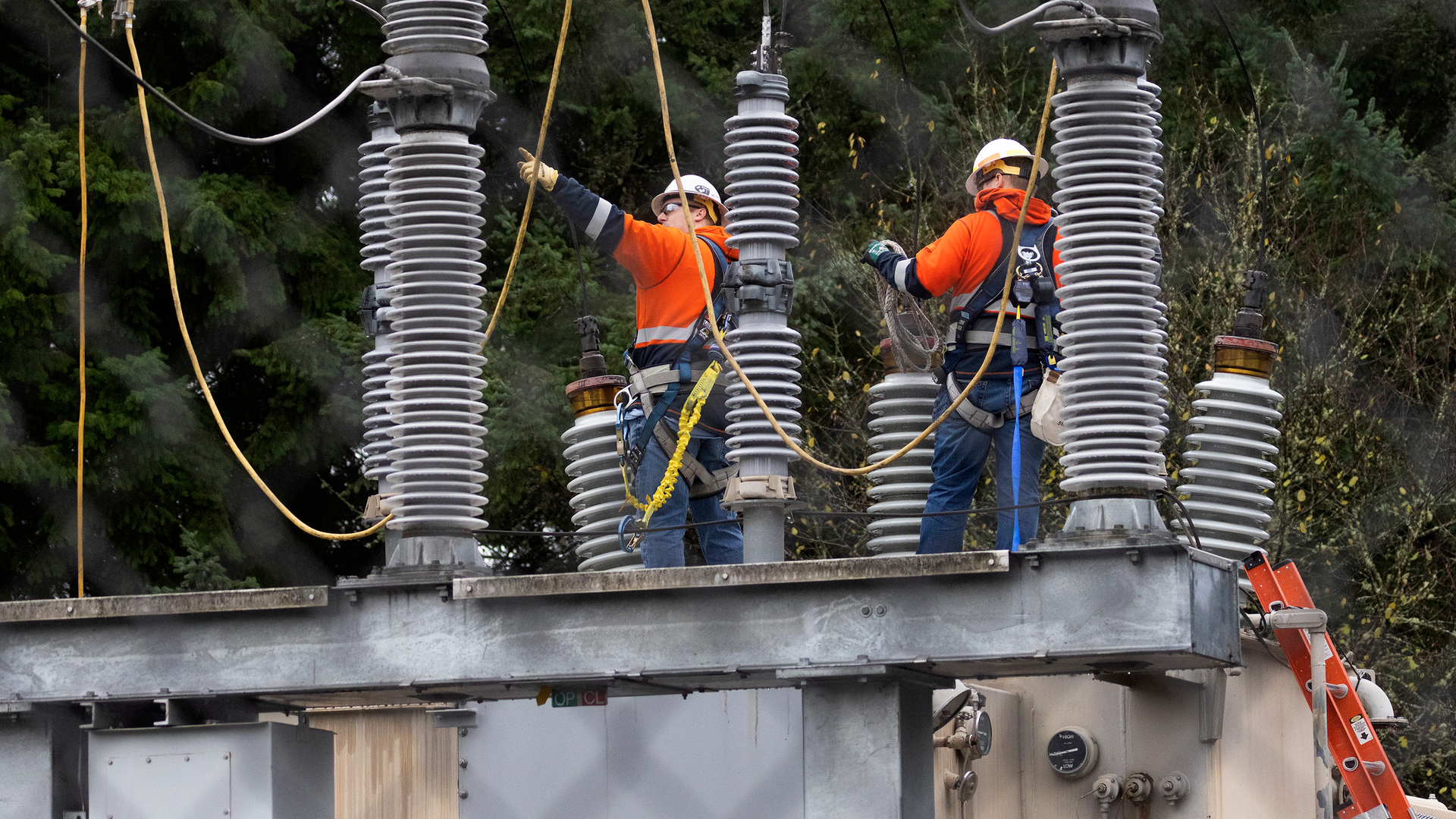 A Tacoma Power crew works at an electrical substation damaged by vandals early Christmas morning in Graham, WA, which caused power outages.