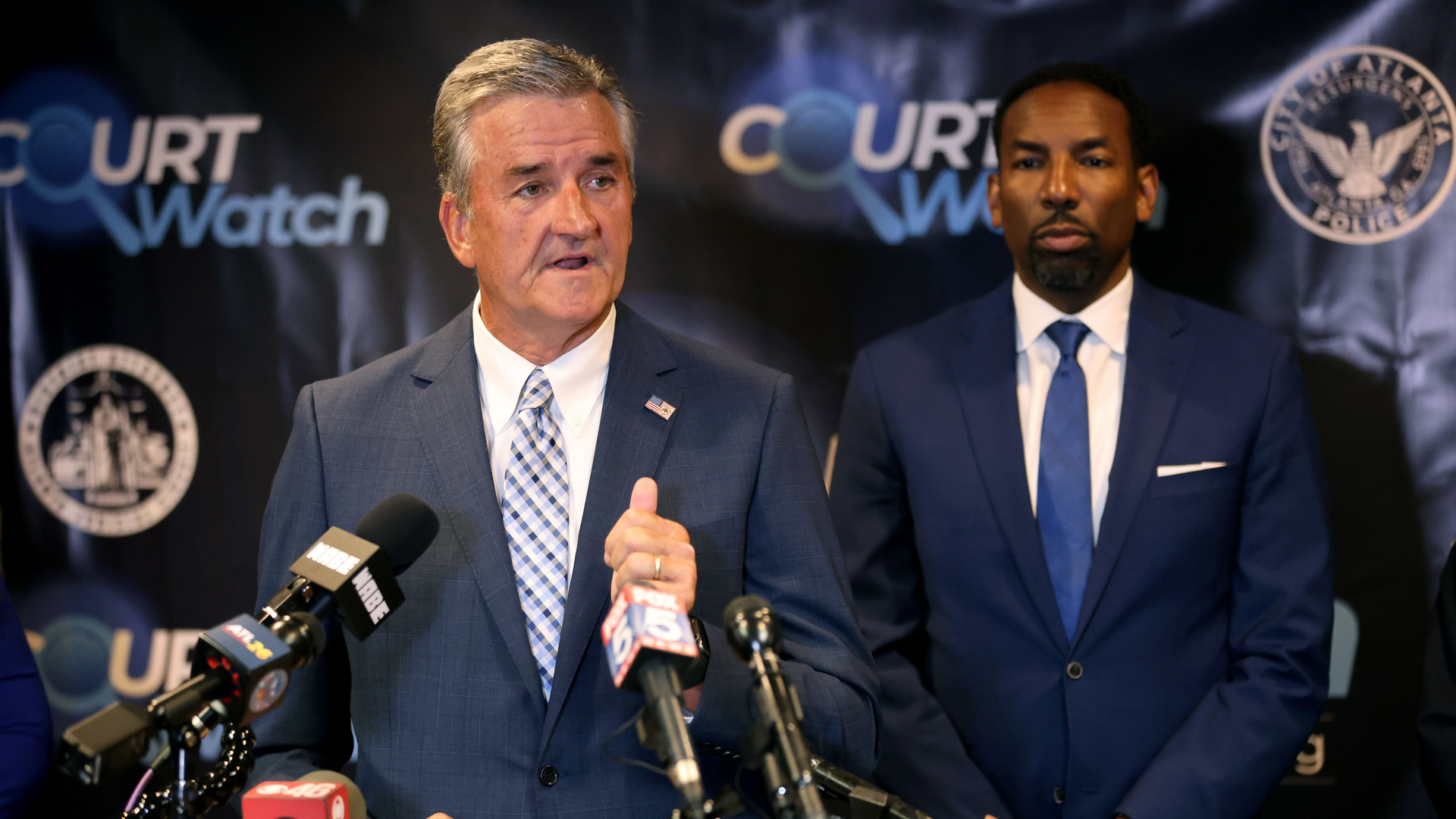 Interim Atlanta Police Foundation President and CEO Dave Wilkinson speaks at a press conference at the Fulton County courthouse in June 13 as Mayor Andre Dickens looks on.