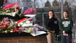 People visit the Spartan statue on the campus of Michigan State University in East Lansing on Tuesday after a gunman opened fire at two locations on the campus Monday night, killing three students and injuring several others. People visit the Spartan statue on the campus of Michigan State University in East Lansing on Tuesday after a gunman opened fire at two locations on the campus Monday night, killing three students and injuring several others.