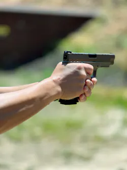 A close-up of the gun shows the striker status indicator. A close-up of the gun shows the striker status indicator.