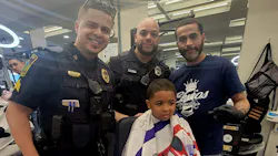 A young man receives a trim as part of East Hartford, CT, Police Department's Haircut With a Cop program Monday. A young man receives a trim as part of East Hartford, CT, Police Department's Haircut With a Cop program Monday.