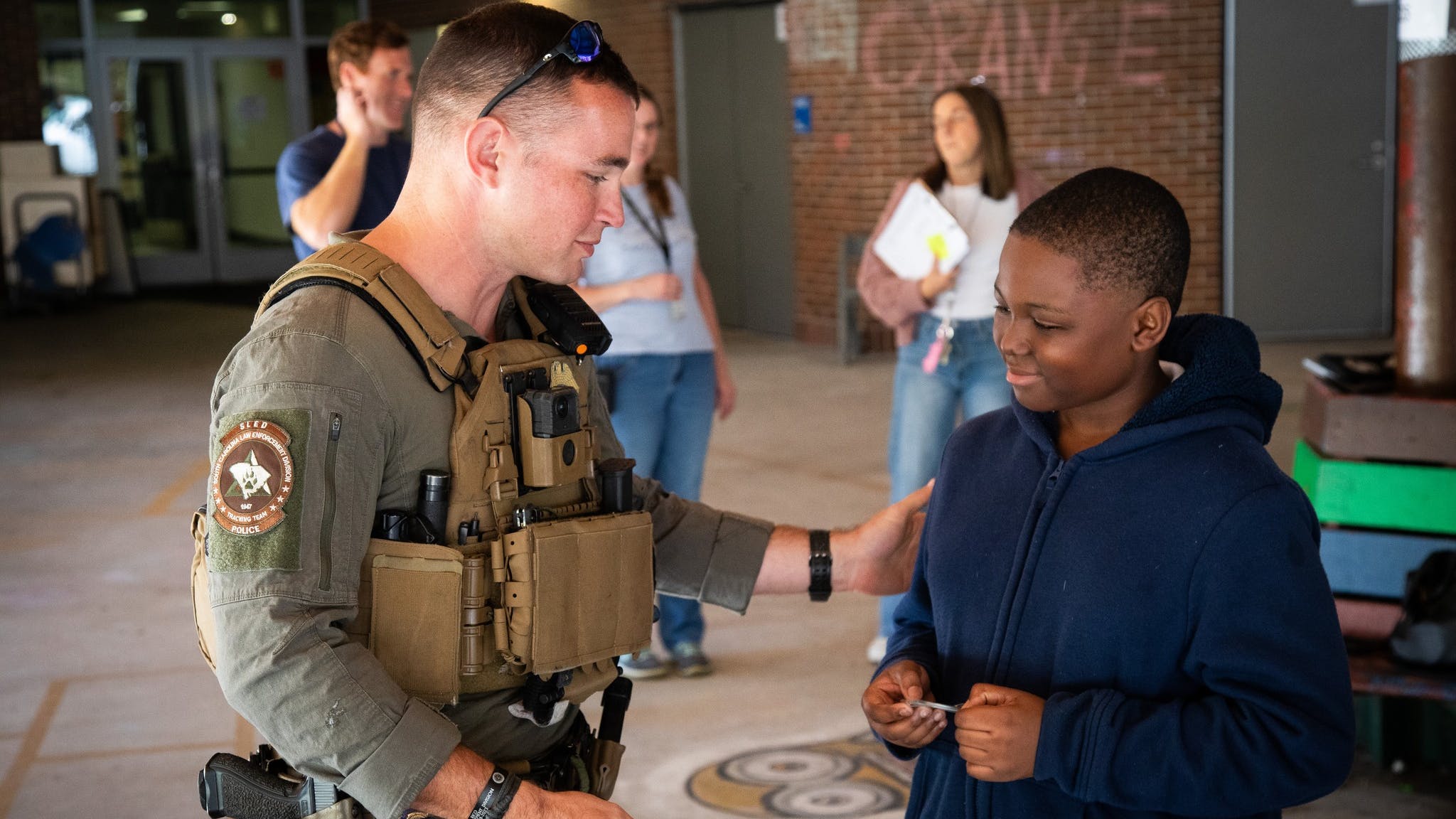 South Carolina Law Enforcement Division Agent Richard Hunton thanks fifth-grader Joel Ekpunobi, who painted a mural of Rico, a K-9 killed during a call in September. Hunton was Rico's handler.