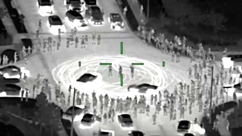 Pandemonium was recorded from above as state troopers and deputies closed in on an illegal street takeover that drew hundreds to an intersection near Tampa, Florida.