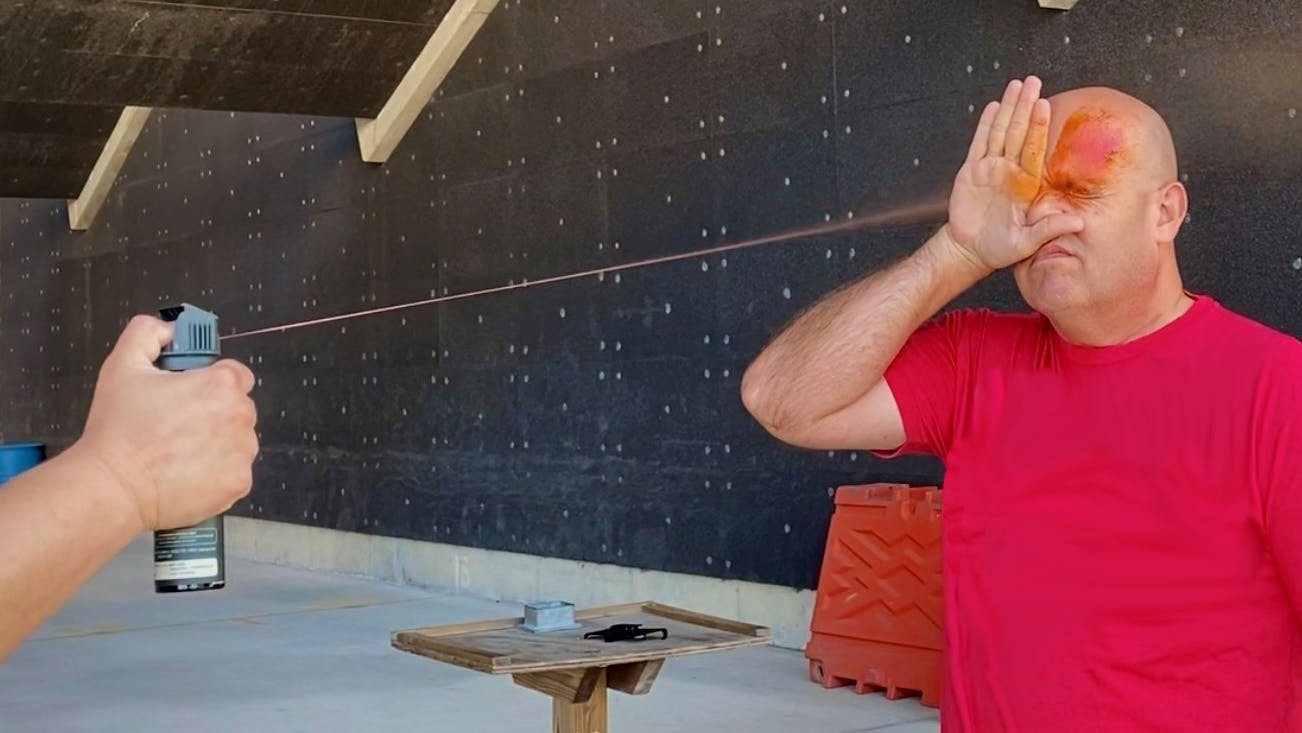 Cpl. Jared Douds (ret.) receives a face full of chemical irritant spray when he volunteered to help test the Defender LE OC product.