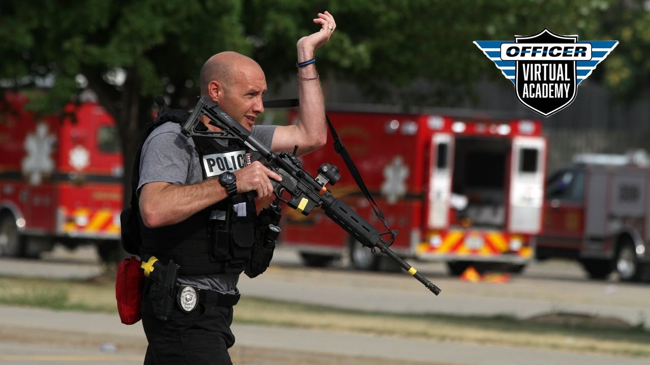 An Indianola, IA, police officer carries a rifle during an active shooter training session.