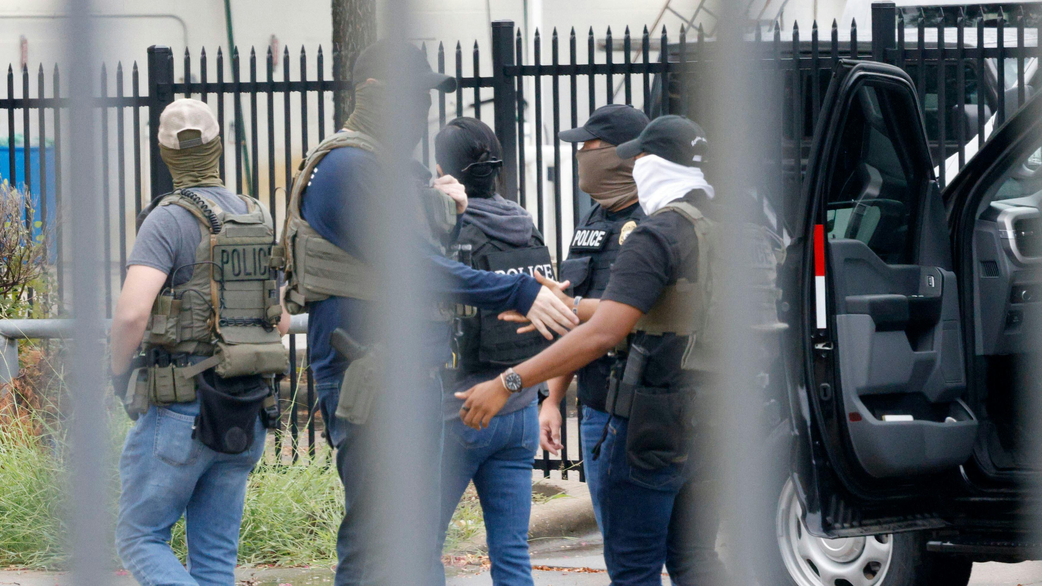 Officers, including Homeland Security Investigations (HIS), gather at the scene of a shooting at a U.S. Immigration and Customs Enforcement office in Dallas on Wednesday.