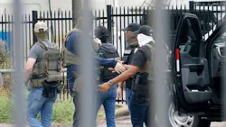 Officers, including Homeland Security Investigations (HIS), gather at the scene of a shooting at a U.S. Immigration and Customs Enforcement office in Dallas on Wednesday. Officers, including Homeland Security Investigations (HIS), gather at the scene of a shooting at a U.S. Immigration and Customs Enforcement office in Dallas on Wednesday.