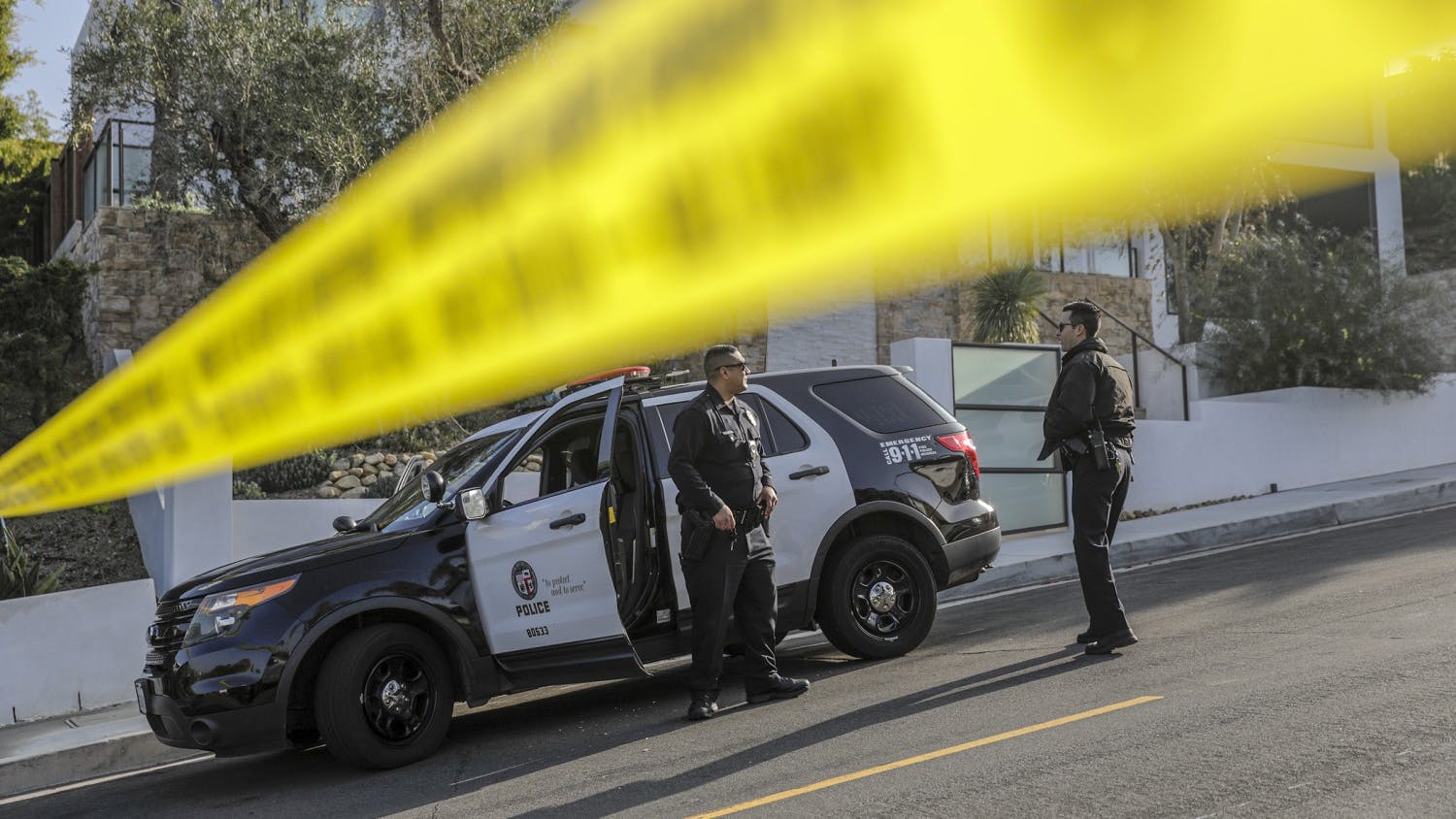 LAPD officers arrive at a crime scene in the Hollywood Hills.