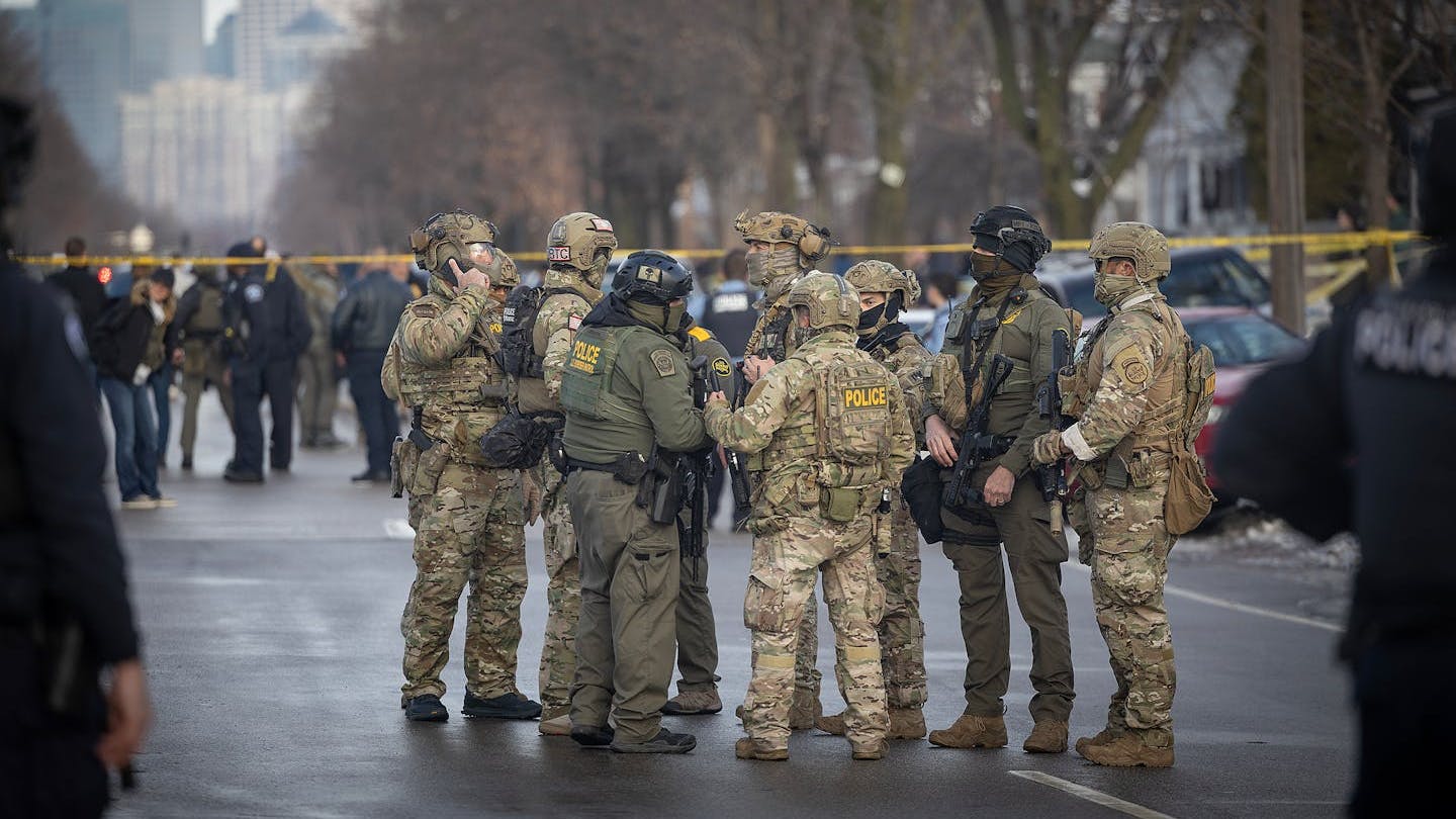 U.S. Border Patrol and law enforcement agents gather at the scene of a shooting near E. 34th Street and Portland Avenue in Minneapolis on Jan. 7.