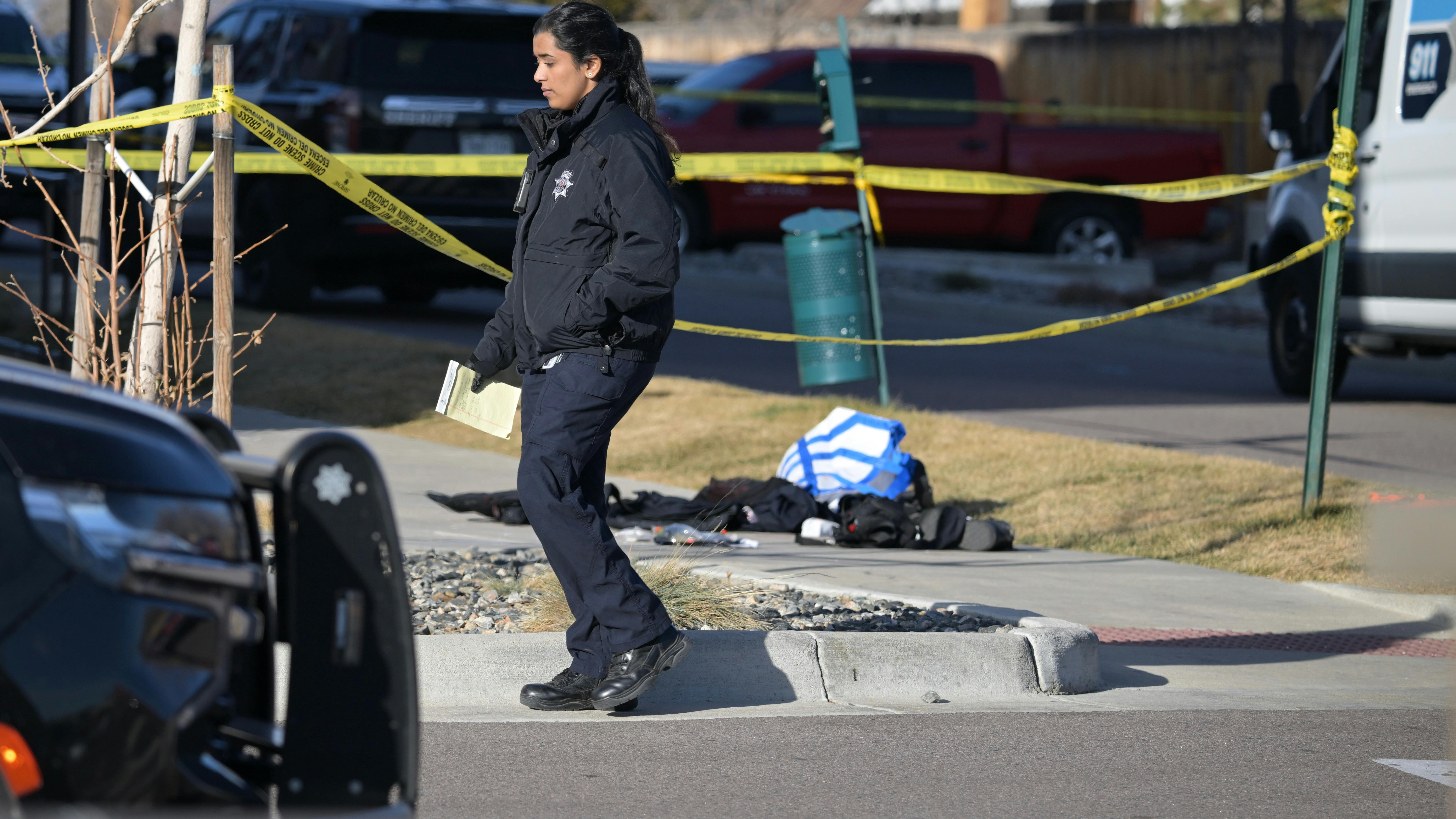 A law enforcement officer at the scene of a shooting near 74th Avenue and Broadway in Denver on Friday morning, Jan. 16, 2026.