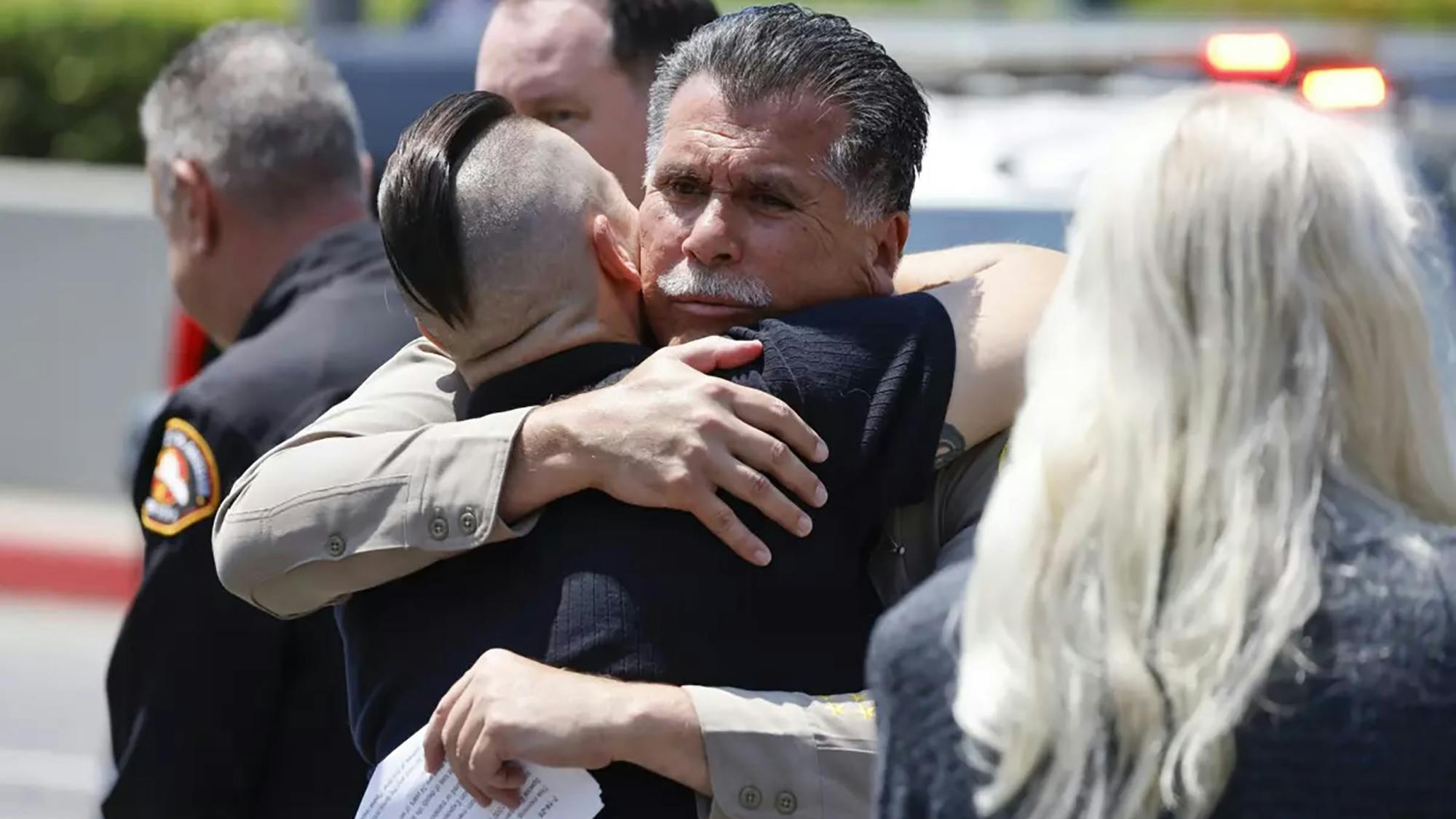 Los Angeles County Sheriff Rober Luna consoles department members