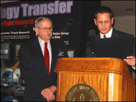 Paul Novak (right) presents a commendation to Delta President Harry Dickinson (left).