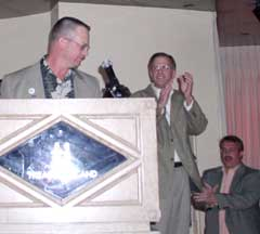 Mike Miller accepts the NBFAA's Sara E. Jackson award while others look on and applaud at the NBFAA awards dinner in Las Vegas.
