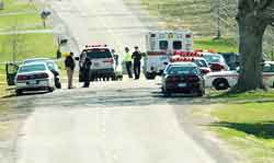 Police surround the scene where a bank robber was killed after a confrontation with a deputy.