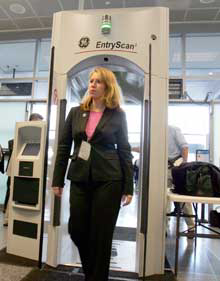 Ann Davis, public affairs manager of Transportation Security Administration, goes through an Explosives Detection Trace Portal machine during a demonstration at the Logan International Airport in Boston, Monday, April 25, 2005. The TSA announced Monday it