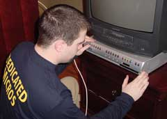 A Dedicated Micros employee installs the company's Digital Sprite 2 multiplexing recording system to manage video cameras installed as part of The Discovery Channel show 'It Takes a Thief'.