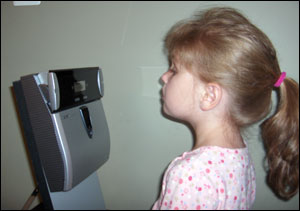 A child uses the Panasonic BM-ET330 iris reader, demonstrating the process it takes to record a child's iris into a national database that will be used to help identify missing children.